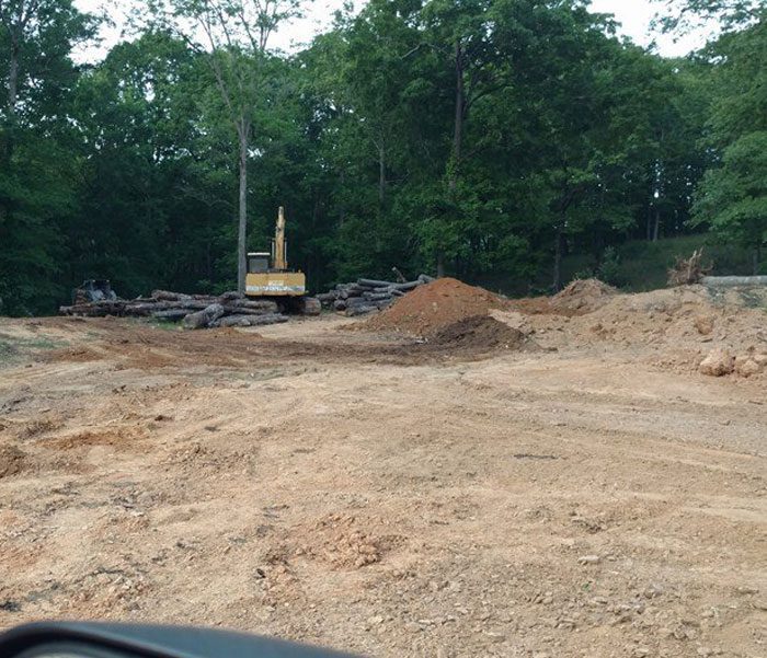 DeBord & Son Construction | clearing trees and debris from a site surrounded by trees